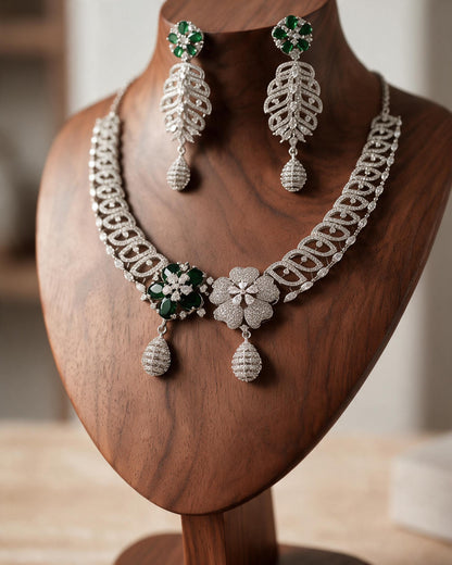 Meher necklace and matching long earrings showing looping silver-tone links and clear decorative accents.